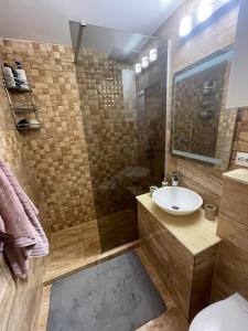 a bathroom with a sink and a shower at Newly renovated chic apartment close to downtown in Satu Mare +8 photos