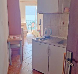 a kitchen with a sink and a counter top at Rooms Beba in Herceg-Novi
