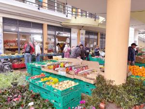 a group of people in a market with fruits and vegetables at Angela`s Loft in Ribeira Brava
