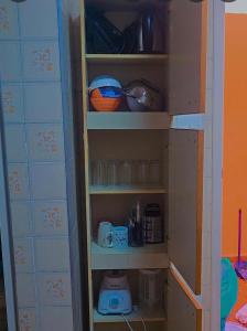 a toy shelf with cups and other items on it at Le house hostel in São Paulo
