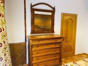 a wooden dresser with a mirror on top of it at A tu Vera in Ventas con Peña Aguilera +36 photos