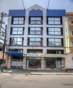 an apartment building with a blue and white facade at Fersal Hotel - Manila in Manila