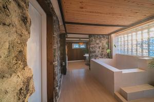 a hallway of a house with a large window at 신흥부부공간b동 in Jeju