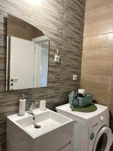 a bathroom with a sink and a mirror at City Place Apartments in Kumanovo