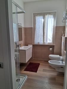 a bathroom with a toilet and a sink and a shower at Che sarà mai in Santa Maria degli Angeli +61 photos