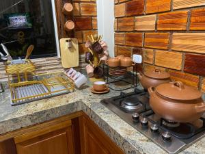 a kitchen counter with pots and pans on a stove at Moyobamba Hosting House in Moyobamba