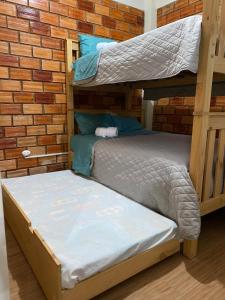 two bunk beds sitting next to a brick wall at Moyobamba Hosting House in Moyobamba