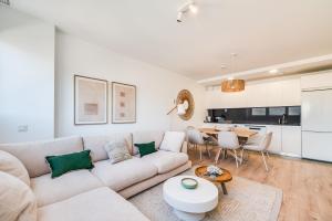 a living room with a white couch and a table at Sky Urban Tower in Málaga +53 photos