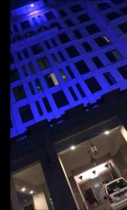 a car is parked in a garage with blue lights at Capitalin in Islamabad