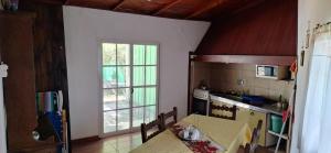 a kitchen with a table and a window in it at Casa Luna in Parana