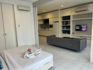 a room with a bed and a living room at Platinum KLCC Suites Face in Kuala Lumpur