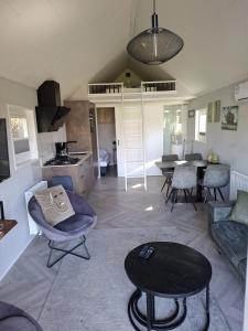 a living room with a couch and a table at Tiny House 303 in Lathum