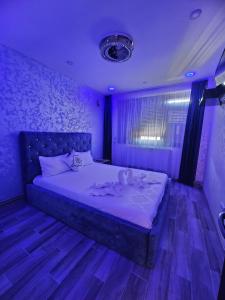 a purple bedroom with a large bed in it at Home LCF in Brăila