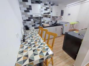 a kitchen with a table and chairs in a room at Apartahotel JDK in Armenia