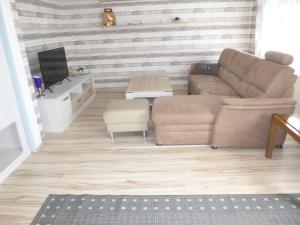 a living room with a couch and a table at Ferienhaus Lisa in Selb