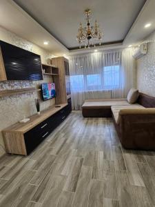 a living room with a couch and a flat screen tv at Home LCF in Brăila