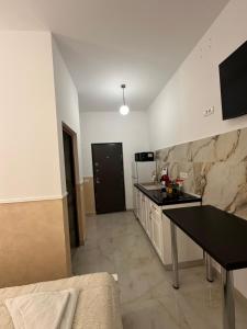 a kitchen with a table and a counter top at Fabian Studio in Tulcea