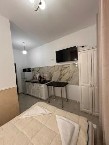 a kitchen with a table and a counter top at Fabian Studio in Tulcea +21 photos