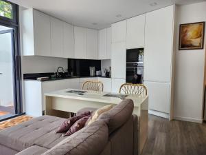 a living room with a couch and a table in a kitchen at Santa Beatriz Apartment in Machico