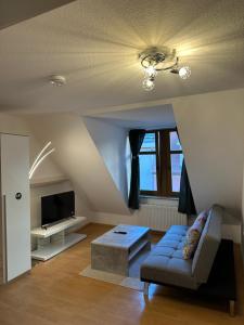 a living room with a couch and a tv at Linda Ninh Apartment 6 Altstadt in Dresden +4 photos
