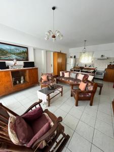 a large living room with couches and a table at Panormitis House in Kefalos