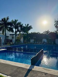 a large swimming pool with palm trees in the background at Casa Residencial la Primavera in Puerto Vallarta