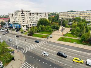 a busy city street with cars on the road at Cozy apartament in Iaşi