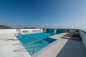 a swimming pool on the side of a building at Sky Urban Tower in Málaga