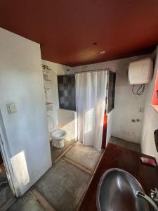 a bathroom with a sink and a toilet at Casa de campo LA FRANCE SA in Riachuelo +34 photos