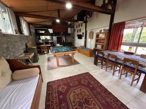 a living room with a pool table and chairs at Casa de campo LA FRANCE SA in Riachuelo