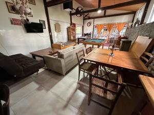 a living room with wooden tables and a couch at Casa de campo LA FRANCE SA in Riachuelo