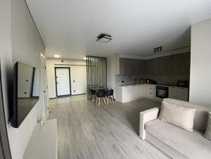 a living room with a couch and a kitchen at Uzhhorod Apartment Lux in Uzhhorod