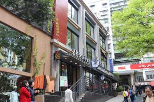 a group of people walking on a city street at The Legend HOME Service Apartment in Guangzhou
