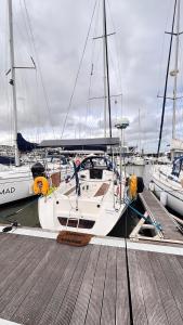 a white boat docked at a dock with other boats at Slowlife in Lisbon +13 photos