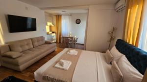a living room with a large bed and a couch at Soko City Center & Parking Free in Soko Banja
