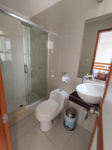 a bathroom with a toilet and a sink and a shower at La Estacion Gran Hotel in Pacasmayo +31 photos
