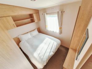 a small room with a bed and a window at 3 Bed Holiday Home - Birchington Vale in Margate +23 photos