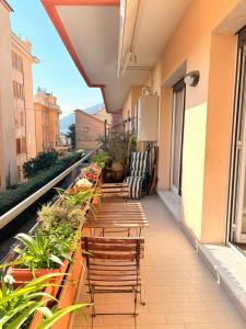 a balcony with chairs and tables on a building at Il Balcone di Anna - Nervi - 65mq Bilocale in Genoa