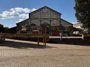 a building with a person walking in front of it at Le Goldorak, Hyper-centre, Garage privé, CLIM et canal plus in Niort
