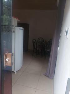 a kitchen with a white refrigerator and a table and chairs at Miraflores 1- The greenhouse in Asuncion +8 photos