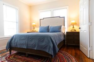 a bedroom with a bed with blue pillows and two lamps at Large fenced yard near town square with Starlink in Gatesville