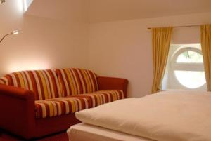 a living room with a couch and a window at Hotel Dolomiten in Collalbo