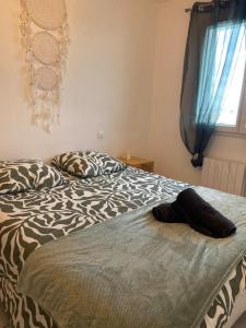 a bedroom with a bed with a zebra print blanket at Le calme à proximité de la mer in Canet-en-Roussillon