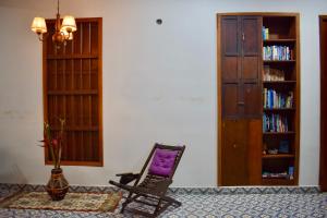 a rocking chair in a room with a book shelf at Hotel Boutique Iyarí in Palmira