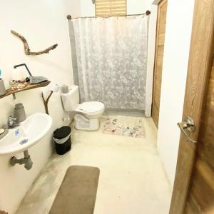 a bathroom with a toilet and a sink at la casablanca moñitos in Moñitos +27 photos