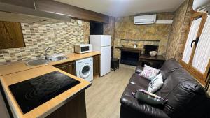 a kitchen and a living room with a couch and a kitchen at Apartamento Corralazos in Castril