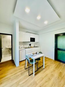 a white kitchen with a table and a counter at VALE MAR Guest in Ribeira Brava +126 photos