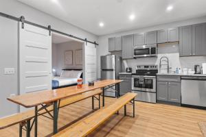 a large kitchen with a wooden table and a bench at Live Like a Local in the Heart of Adams Morgan in Washington, D.C.