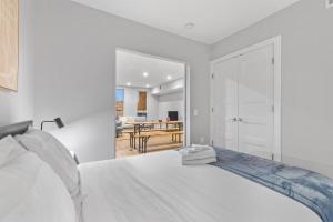 a white bedroom with a bed and a dining room at Live Like a Local in the Heart of Adams Morgan in Washington, D.C. +7 photos