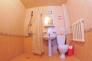 a bathroom with a toilet and a sink at Sukhrob Barzu Hotel in Bukhara +37 photos